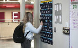 Illustrative: A US ninth grader places her cellphone in to a phone holder as she enters class at Delta High School, February 23, 2024, in Delta, Utah. (AP Photo/Rick Bowmer)