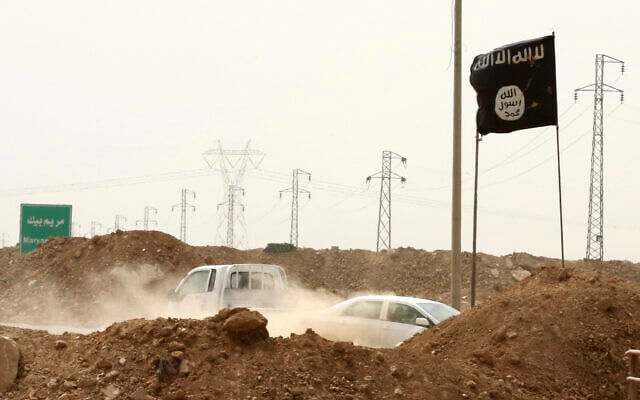 FILE - Islamic State militants pass a checkpoint bearing the group's trademark black flag in the village of Maryam Begg in Kirkuk, 180 miles north of Baghdad, Iraq, Sept. 29, 2014. (AP Photo/Hadi Mizban, File) FILE - Islamic State militants pass a checkpoint bearing the group's trademark black flag in the village of Maryam Begg in Kirkuk, 180 miles north of Baghdad, Iraq, Sept. 29, 2014. (AP Photo/Hadi Mizban, File)