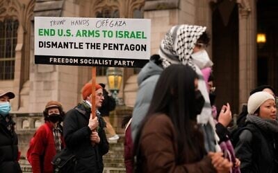 Illustrative: A protester marches with a sign calling for the United States to stop supplying weapons to Israel during a pro-Palestinian, anti-Israel protest at the University of Washington campus, February 5, 2025, in Seattle. (AP Photo/Lindsey Wasson)