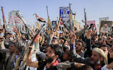 Houthi supporters raise weapons as they shout slogans during an anti-USand anti-Israel rally in Sanaa, Yemen, on February 14, 2025. (AP Photo/Osamah Abdulrahman)