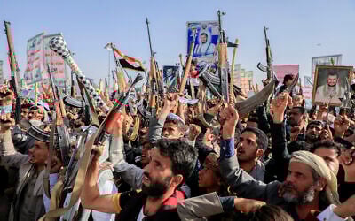 Houthi supporters raise weapons as they shout slogans during an anti-USand anti-Israel rally in Sanaa, Yemen, on February 14, 2025. (AP Photo/Osamah Abdulrahman)