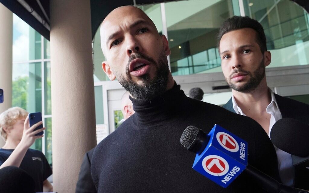 Self-proclaimed misogynist social media influencer Andrew Tate addresses the media as his brother Tristan looks on, after arriving in Fort Lauderdale, Florida, February 27, 2025. (AP Photo/Marta Lavandier) Self-proclaimed misogynist social media influencer Andrew Tate addresses the media as his brother Tristan looks on, after arriving in Fort Lauderdale, Florida, February 27, 2025. (AP Photo/Marta Lavandier)