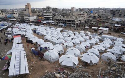 A sprawling tent camp for displaced Palestinians sits adjacent to destroyed homes and buildings in Gaza City, Gaza Strip, March 1, 2025 during the Muslim holy month of Ramadan. (AP Photo/Abdel Kareem Hana)