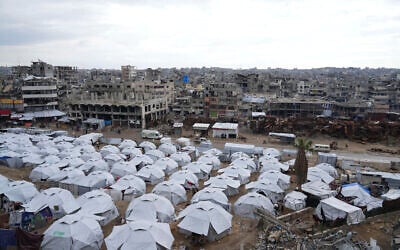 A sprawling tent camp for displaced Palestinians sits adjacent to destroyed homes and buildings in Gaza City, Gaza Strip, March 1, 2025, during the Muslim holy month of Ramadan. (AP Photo/Abdel Kareem Hana)