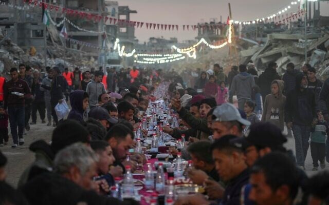 Palestinians sit at a large table surrounded by the rubble of destroyed homes and buildings as they gather for iftar, the fast-breaking meal, on the first day of Ramadan in Rafah, southern Gaza Strip, March 1, 2025 (AP Photo/Abdel Kareem Hana) Palestinians sit at a large table surrounded by the rubble of destroyed homes and buildings as they gather for iftar, the fast-breaking meal, on the first day of Ramadan in Rafah, southern Gaza Strip, March 1, 2025 (AP Photo/Abdel Kareem Hana)