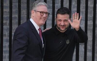 Britain's Prime Minister Keir Starmer, left, greets Ukraine's President Volodymyr Zelensky in Downing Street, London, England, Saturday, March 1, 2025. (AP Photo/Kin Cheung)