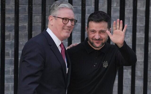 Britain's Prime Minister Keir Starmer, left, greets Ukraine's President Volodymyr Zelensky in Downing Street, London, England, Saturday, March 1, 2025. (AP Photo/Kin Cheung)