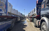 Trucks line up at the Egyptian side of the Rafah border crossing between Egypt and the Gaza Strip after Israel blocked the entry of aid trucks into Gaza, March 2, 2025. (AP Photo/Mohamed Arafat)