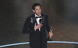 Adrien Brody accepts the award for best performance by an actor in a leading role for "The Brutalist" during the Oscars on March 2, 2025, at the Dolby Theatre in Los Angeles. (AP Photo/Chris Pizzello)