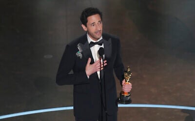 Adrien Brody accepts the award for best performance by an actor in a leading role for "The Brutalist" during the Oscars on March 2, 2025, at the Dolby Theatre in Los Angeles. (AP Photo/Chris Pizzello)