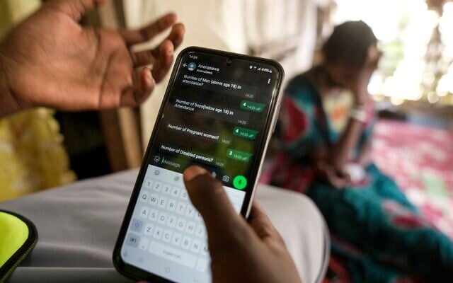 A woman chats with an Israel-based organization (IsraAID) chatbot in Juba displacement camp, South Sudan, February 12, 2025. (AP Photo/Brian Inganga) A woman chats with an Israel-based organization (IsraAID) chatbot in Juba displacement camp, South Sudan, February 12, 2025. (AP Photo/Brian Inganga)