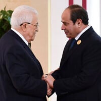 Egyptian President Abdel-Fattah el-Sissi, right, greets Palestinian Authority President Mahmoud Abbas during the emergency Arab summit at Egypt's New Administrative Capital, just outside Cairo, March 4, 2025. (Egyptian Presidency Media Office via AP)