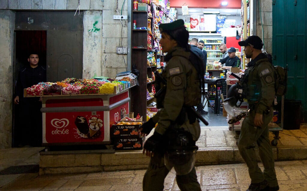 Israeli border police patrol as shopkeepers break their fast during the Muslim holy month of Ramadan in the Old City of Jerusalem, Wednesday, March 5, 2025. (AP Photo/Maya Alleruzzo)
