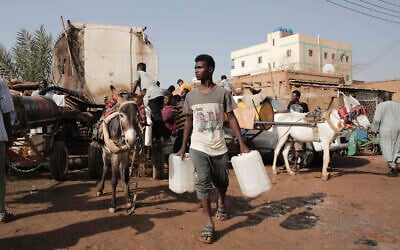 People gather to collect water in Khartoum, Sudan, May 28, 2023. (Marwan Ali/AP)