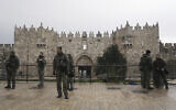Israeli Border Police stand guard at the Damascus Gate to the Old City of Jerusalem as worshippers make their way to the Al-Aqsa Mosque compound for the first Friday Prayers of the Muslim holy month of Ramadan, March 7, 2025. (AP Photo/Mahmoud Illean)