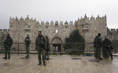 Israeli Border Police stand guard at the Damascus Gate to the Old City of Jerusalem as worshippers make their way to the Al-Aqsa Mosque compound for the first Friday Prayers of the Muslim holy month of Ramadan, March 7, 2025. (AP Photo/Mahmoud Illean)