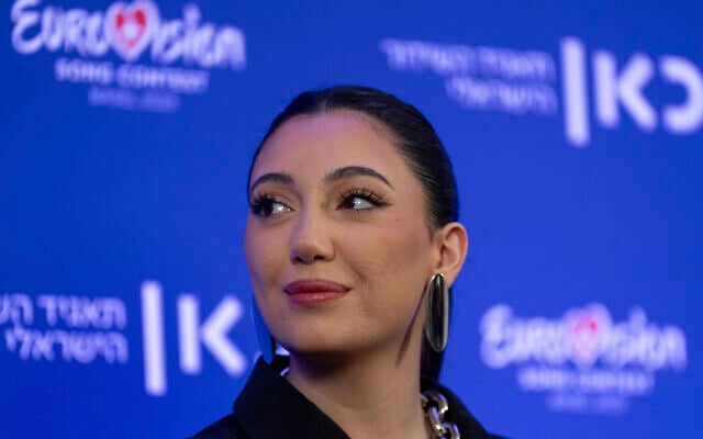 Yuval Raphael, Israel's Eurovision 2025 representative and survivor of the Oct. 7 attacks at the Nova music festival, speaks to the media after premiering the song 'A New Day Will Rise, in Tel Aviv, Israel, March 9, 2025. (AP Photo/Ohad Zwigenberg)