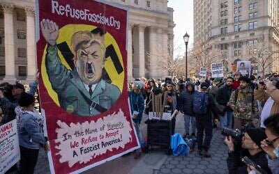 Demonstrators raise a sign depicting President Donald Trump as Adolf Hitler during a protest in support of Palestinian activist Mahmoud Khalil, March 10, 2025, in New York. (AP Photo/Yuki Iwamura)