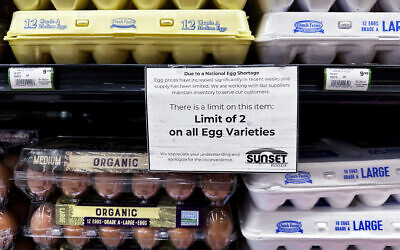 A sign is mounted on a shelve of eggs at a grocery store in Northbrook, Illinois, February 28, 2025. (AP Photo/Nam Y. Huh)