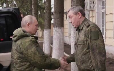 In this image made from video released by the Russian Presidential Press Service, March 12, 2025, Russian President Vladimir Putin, left, shakes hands with Russian Chief of General Staff Gen. Valery Gerasimov as he visits military headquarters in the Kursk region of Russia. (Russian Presidential Press Service via AP)