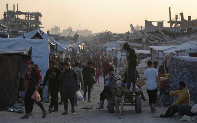 Palestinians walk amid the rubble of destroyed homes and buildings in Jabalia, northern Gaza Strip, March 14, 2025. (AP/Jehad Alshrafi) Palestinians walk amid the rubble of destroyed homes and buildings in Jabalia, northern Gaza Strip, March 14, 2025. (AP/Jehad Alshrafi)