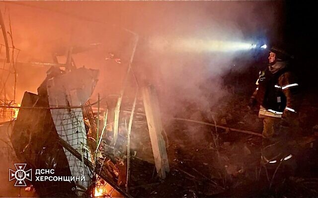 In this photo provided by the Ukrainian Emergency Service, firefighters put out the fire at the private houses following a Russian guided air bombs attack in Kherson, Ukraine, March 15, 2025. (Ukrainian Emergency Service via AP)