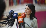 Germany's Foreign Minister Annalena Baerbock speaks with the media as she arrives for a meeting of EU foreign ministers at the European Council building in Brussels, Monday, March 17, 2025. (AP Photo/Virginia Mayo)