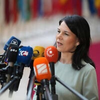 Germany's Foreign Minister Annalena Baerbock speaks with the media as she arrives for a meeting of EU foreign ministers at the European Council building in Brussels, Monday, March 17, 2025. (AP Photo/Virginia Mayo)