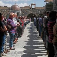 Syrian men pray during the funeral of Muhannad Akrad, one of three people killed in Israeli airstrikes on Monday, at the Omary mosque in Daraa, southern Syria, March 18, 2025. (AP Photo/Omar Sanadiki)
