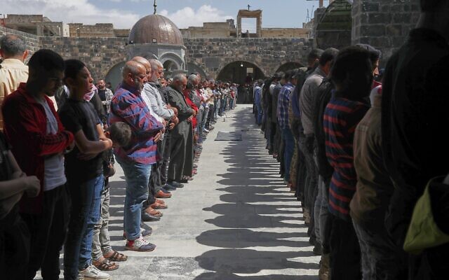 Syrian men pray during the funeral of Muhannad Akrad, one of three people killed in Israeli airstrikes on Monday, at the Omary mosque in Daraa, southern Syria, March 18, 2025. (AP Photo/Omar Sanadiki) Syrian men pray during the funeral of Muhannad Akrad, one of three people killed in Israeli airstrikes on Monday, at the Omary mosque in Daraa, southern Syria, March 18, 2025. (AP Photo/Omar Sanadiki)