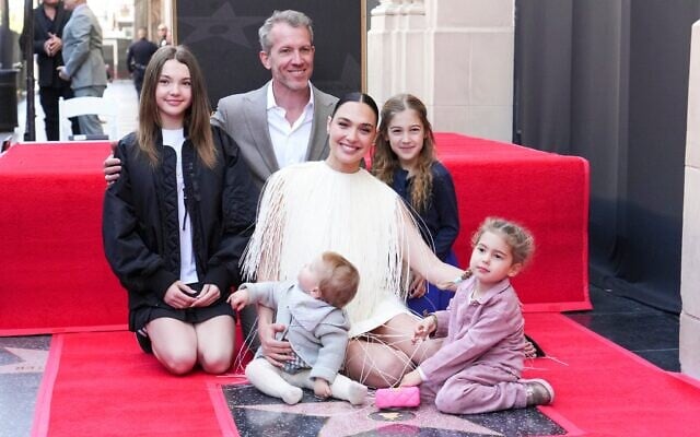 Alma Varsano, from left, Jaron Varsano, Ori Varsano, Gal Gadot, Maya Varsano, and Daniella Varsano pose with Gadot's new star during a ceremony on the Hollywood Walk of Fame on March 18, 2025, in Los Angeles. (Jordan Strauss/Invision/AP)