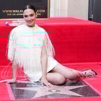 Gal Gadot poses with her new star at a ceremony honoring her on the Hollywood Walk of Fame on March 18, 2025, in Los Angeles. (Jordan Strauss/Invision/AP)