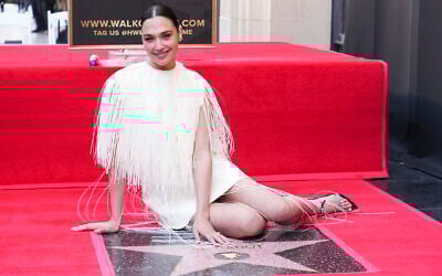 Gal Gadot poses with her new star at a ceremony honoring her on the Hollywood Walk of Fame on March 18, 2025, in Los Angeles. (Jordan Strauss/Invision/AP)