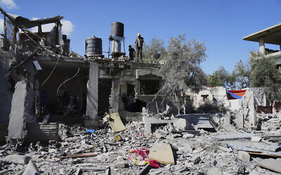 Palestinians inspect their damaged house following an Israeli strike in Deir al-Balah, Gaza Strip on Wednesday, March 19, 2025. (AP Photo/Abdel Kareem Hana)