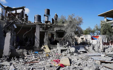 Palestinians inspect their damaged house following an Israeli strike in Deir al-Balah, Gaza Strip on Wednesday, March 19, 2025. (AP Photo/Abdel Kareem Hana)