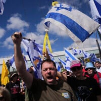 Israelis march in a protest against Prime Minister Benjamin Netanyahu and his plans to dismiss the head of the Shin Bet internal security service, in Jerusalem on March 19, 2025. (AP Photo/Ohad Zwigenberg)