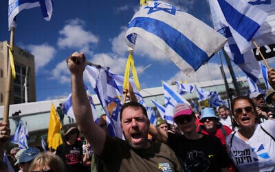 Israelis march in a protest against Prime Minister Benjamin Netanyahu and his plans to dismiss the head of the Shin Bet internal security service, in Jerusalem on March 19, 2025. (AP Photo/Ohad Zwigenberg)