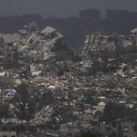 Buildings destroyed during the Israeli air and ground offensive in the Gaza Strip as seen from southern Israel, Thursday, March 20, 2025. (AP/Leo Correa)