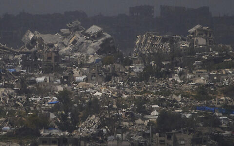Buildings destroyed during the Israeli air and ground offensive in the Gaza Strip as seen from southern Israel, Thursday, March 20, 2025. (AP/Leo Correa)