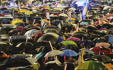 Israelis attend a rally against Prime Minister Benjamin Netanyahu's plan to dismiss the head of the Shin Bet internal security service, and calling for the release of hostages held by Hamas in the Gaza Strip, outside the Knesset, Israel's parliament in Jerusalem on Thursday, March 20, 2025. (AP Photo/Ohad Zwigenberg)