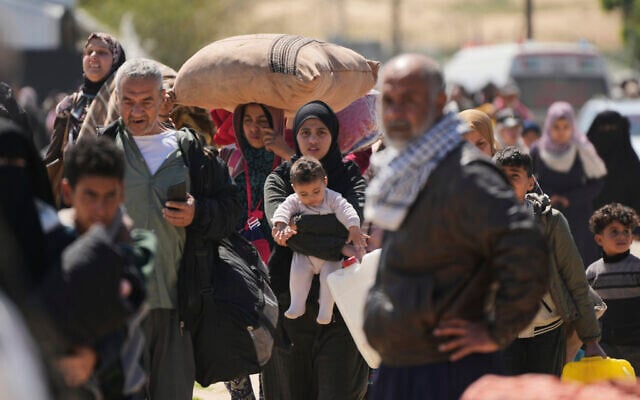 Displaced Palestinians fleeing from Rafah amidst renewed fighting, arrive in Khan Younis, Gaza, on March 23, 2025. (AP Photo/Abdel Kareem Hana) Displaced Palestinians fleeing from Rafah amidst renewed fighting, arrive in Khan Younis, Gaza, on March 23, 2025. (AP Photo/Abdel Kareem Hana)