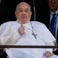 Pope Francis makes a thumbs-up gesture as he appears at a window of the Agostino Gemelli Polyclinic in Rome, March 23, 2025, where he has been treated for bronchitis and bilateral pneumonia since February 14. (AP Photo/Domenico Stinellis)