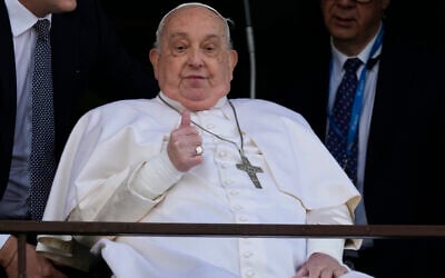 Pope Francis makes a thumbs-up gesture as he appears at a window of the Agostino Gemelli Polyclinic in Rome, March 23, 2025, where he has been treated for bronchitis and bilateral pneumonia since February 14. (AP Photo/Domenico Stinellis)