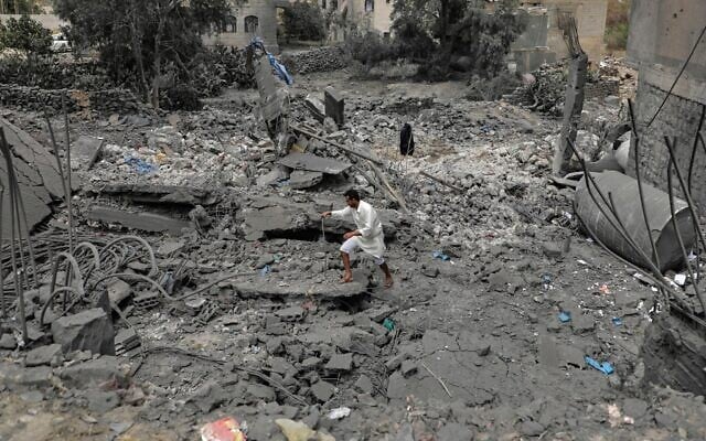 A Yemeni walks over the debris of a destroyed building following US airstrikes in Sanaa, Yemen, March 24, 2025. (AP) A Yemeni walks over the debris of a destroyed building following US airstrikes in Sanaa, Yemen, March 24, 2025. (AP)