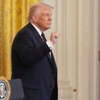 US President Donald Trump gestures as he departs a reception celebrating Greek Independence Day in the East Room of the White House, in Washington, DC, March 24, 2025. (AP Photo/Jacquelyn Martin)