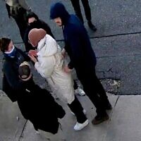 In this image taken from security camera video, Rumeysa Ozturk, a 30-year-old doctoral student at Tufts University, is detained by Department of Homeland Security agents on a street in Somerville, Massachusetts, March 26, 2025. (AP Photo)