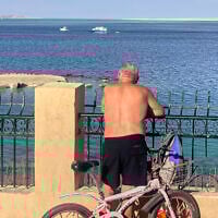 A tourist watches search operations in the area where a tourist submarine sank in the popular Egyptian Red Sea destination of Hurghada, Egypt, March 27, 2025. (AP)