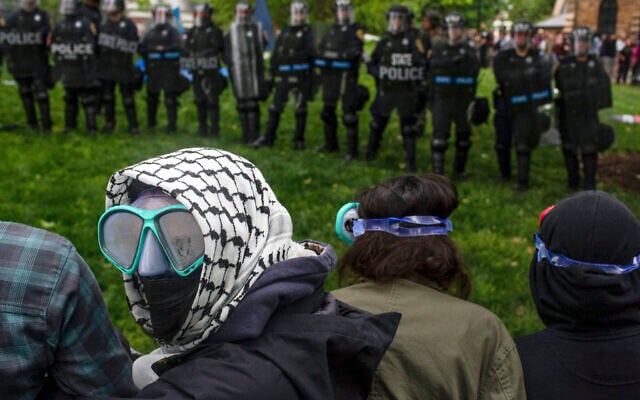 Pro-Palestinian, anti-Israel demonstrators line up across from police on University of Virginia campus in Charlottesville, Va., May 4, 2024. (Cal Cary/The Daily Progress via AP)