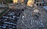 Palestinians attend Eid al-Fitr prayer in the central Gaza Strip's Deir al-Balah, March 30, 2025. (AP Photo/Abdel Kareem Hana)