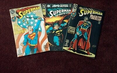 An undated photo shows three editions of the 'Superman' comic book. (AP Photo/ Ed Bailey)